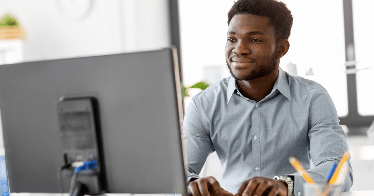 Man typing on a desktop computer