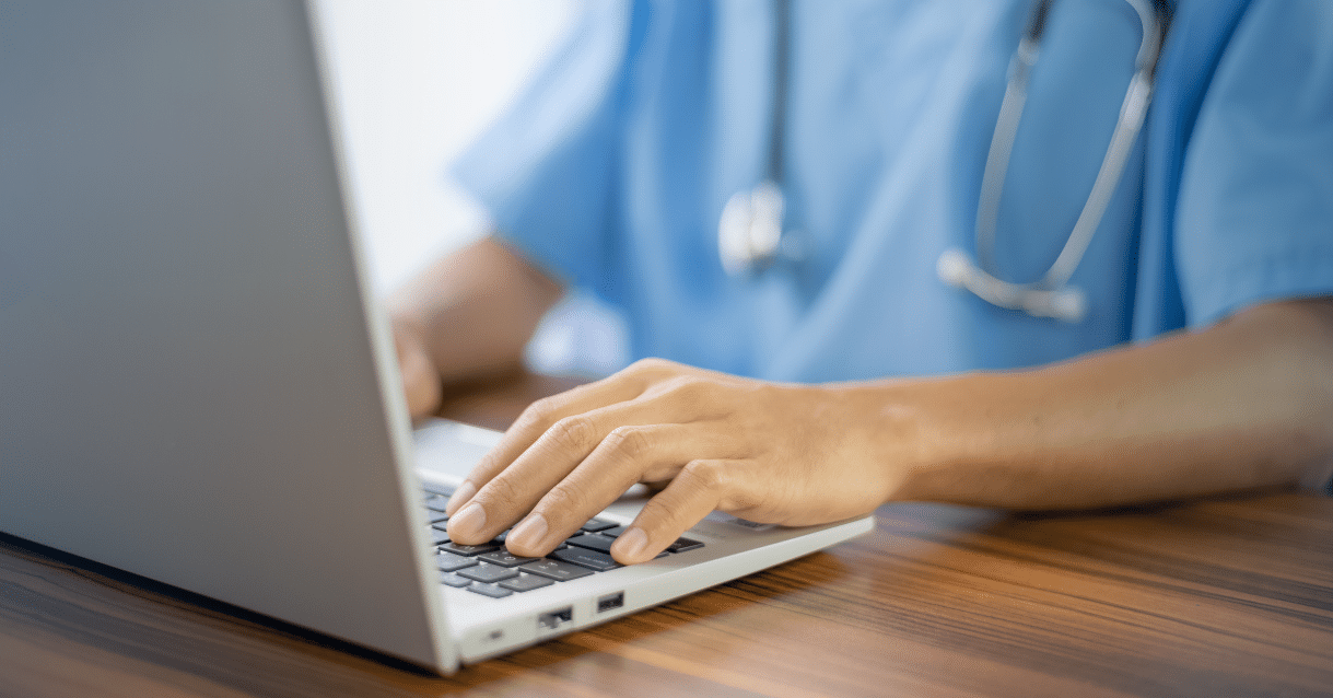 Female doctor typing on a laptop