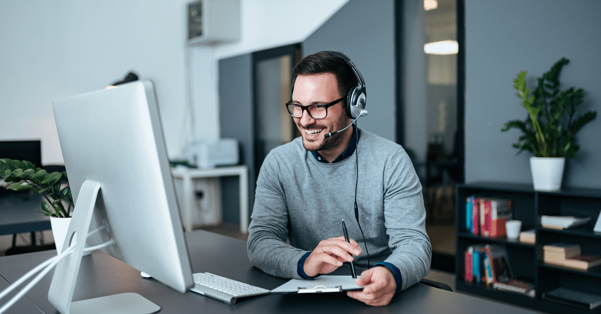 Man smiling while talking on the phone