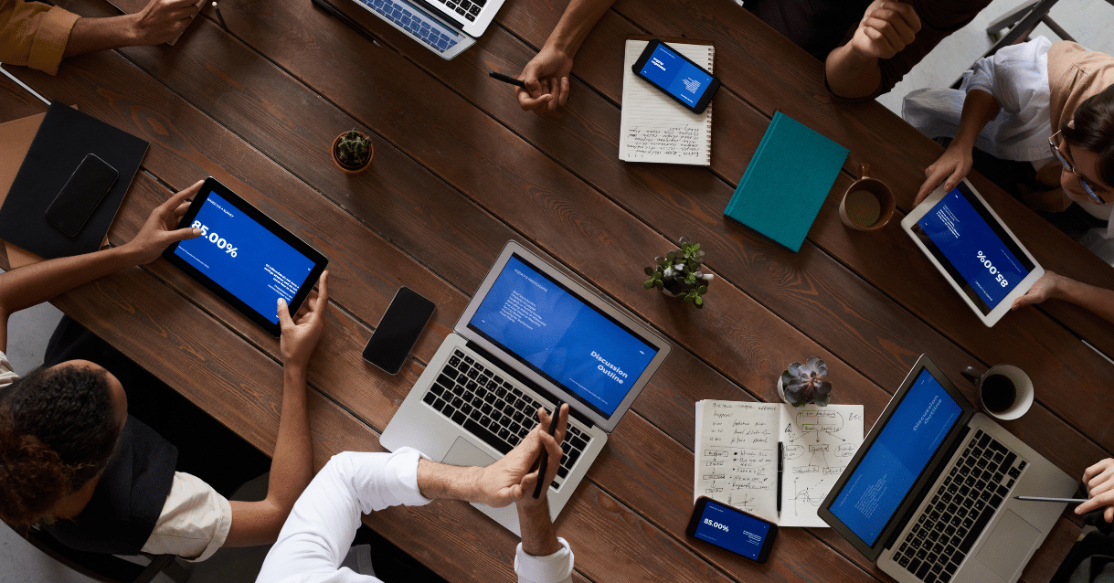 Overhead image of multiple business people on computers
